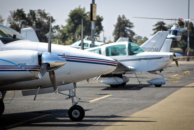 Beechcraft 55 Baron (N1835B) - Helicopter playing some hide and seek with the Baron at Reid Hillview.
