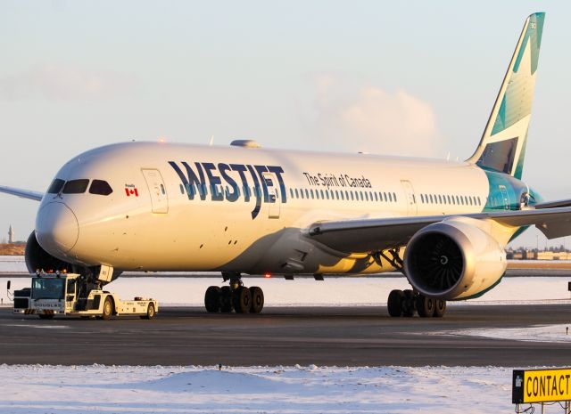 Boeing 787-9 Dreamliner (C-GUDO) - Being towed to the gate before heading off to London Gatwick as "WestJet 1 Heavy".