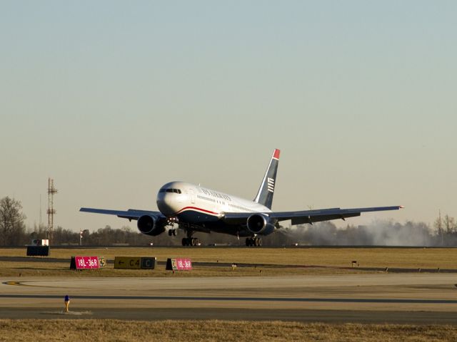 N249AY — - This Boeing 767 is just landing in Charlotte, North Carolina USA from Rome, Italy on a cold December afternoon. Its main wheels are firmly on the runway and the wing spoilers have deployed to help slow the airplane down. The nose is will gently touch down momentarily. This aircraft was unloaded, cleaned, refueled, got a main tire replaced, reloaded with fresh food, a new flight crew, and cargo bays full of freight and goodies for Christmas, and a full load of passengers all in about two hours total time. Then, this great old bird blasted back into the dark,wintry sky for the long trip back to Rome, Italy.