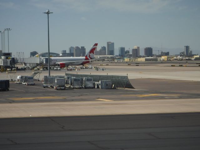 — — - View of Phoenix, Arizona from the Sky Harbor Airport with an Air Canada flight in the foreground