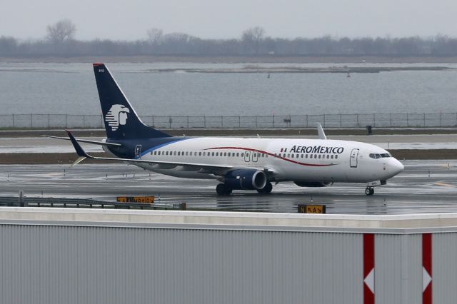 Boeing 737-800 (N845AM) - AMX402 arriving from Mexico City on a rainy day at JFK.  Seen from the Airtrain on the way to the JetBlue terminal so apologies for quality.