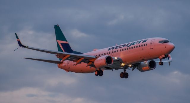 Boeing 737-800 (C-GWSX) - The setting sun casts a pink hue on this Westjet 738