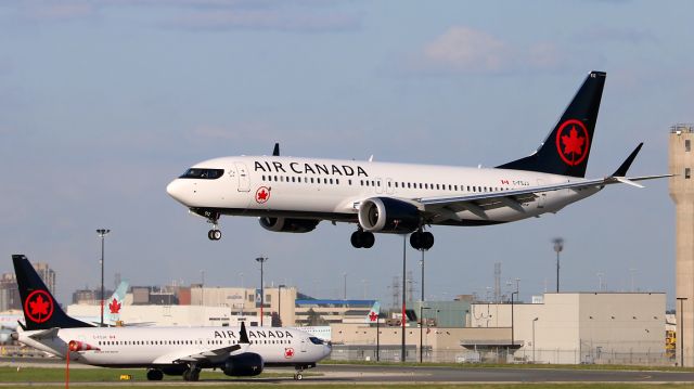 Boeing 737 MAX 8 (C-FSJJ) - Twins: Fin 512 landing while Fin 511 is taxiing in