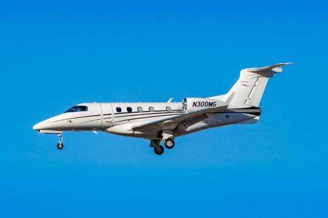 Embraer Phenom 300 (N300MG) - An Embraer Phenom 300 landing at PHX on 2/5/23. Taken with a Canon R7 and Tamron 70-200 G2 lens.