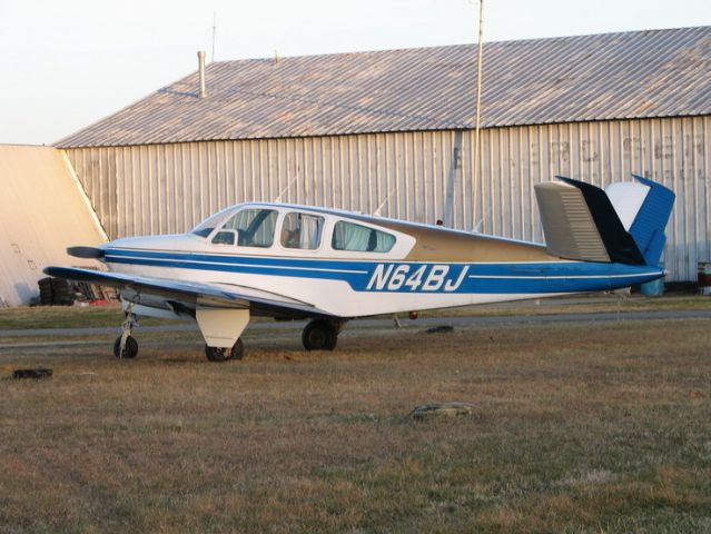 Beechcraft 35 Bonanza (N64BJ) - Lee airport near Annapolis, MD is a unique airport.  It has mostly open bay hangers and uncprotected parking.  This guy was parked outside.