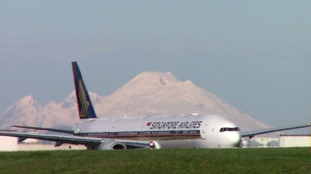 BOEING 777-300 (9V-SNC) - Singapores last 777, 9V-SNC, taxiing to Runway 34L at KPAE last week for a Customer Acceptance (C1) Test Flight. Beautiful Mt. Baker is in the background and the heat of the runway gave an awesome effect to the glorious beast below! :)