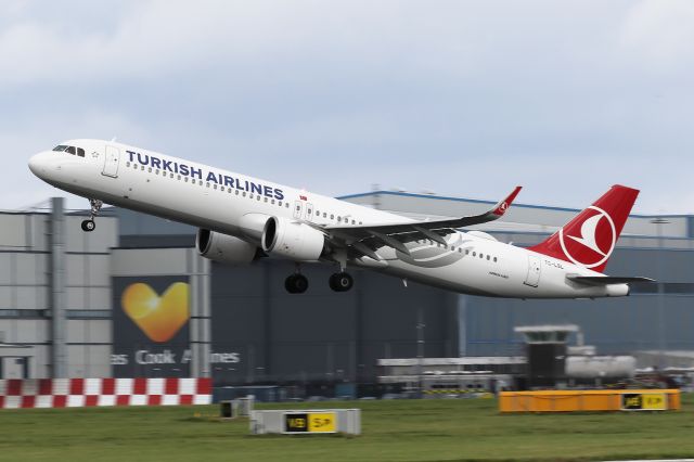 Airbus A321neo (TC-LSL) - TK1994 climbing past the assorted hangars at Manchester on the way back to Istanbul