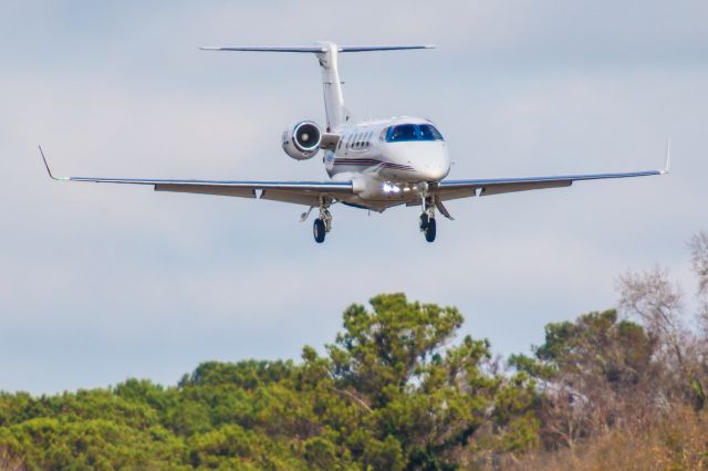 Embraer Phenom 300 (N85BZ) - This is a photo of a 2012 Embraer Phenom 300 on final for Atlanta's PDK executive airport. I shot this with a Canon 800mm lens. The camera settings were 1/2000 shutter, F5.6 ISO 250. I really appreciate POSITIVE VOTES & POSITIVE COMMENTS. Please check out my other aircraft photography. Questions about this photo can be sent to Info@FlewShots.com