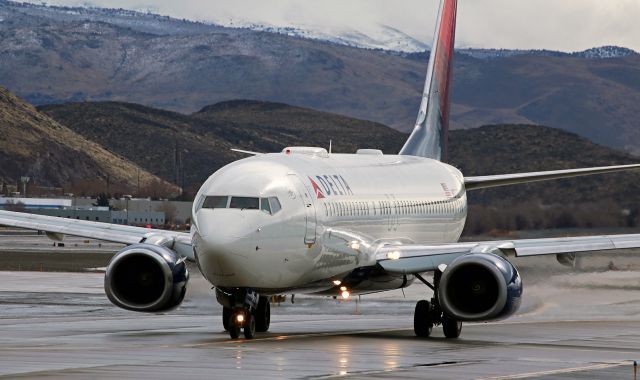 Boeing 737-800 (N3733Z) - The rain had stopped a few minutes before this Delta B738 taxied up to my position before turning and lining up to depart on 16R.