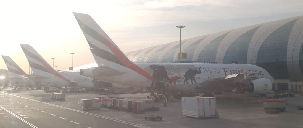 Airbus A380-800 (A6-EER) - Panoramic shot during pushback from Emirates dedicated Airbus A380 terminal with three other A380s