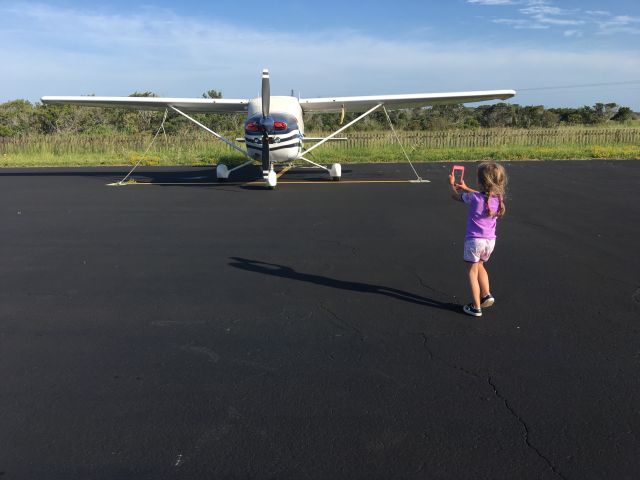 Cessna Skylane (N735J) - I told my daughter I was going "planespotting" while we were camping at Ocracoke Island. She said she wanted to try, so here she is on her first planespotting session. This C182 flies to Ocracoke even more than I do... which I didn't think was possible!