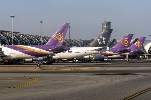 Boeing 747-400 (HS-TGW) - 21st Dec., 2019: Line up of heavies at Bangkok's Suvarnabhumi International Airport. 