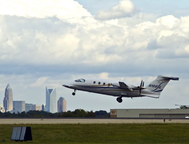 Piaggio P.180 Avanti (N188SL) - Taking off from runway 36R with beautiful downtown Charlotte, North Carolina USA in the background.