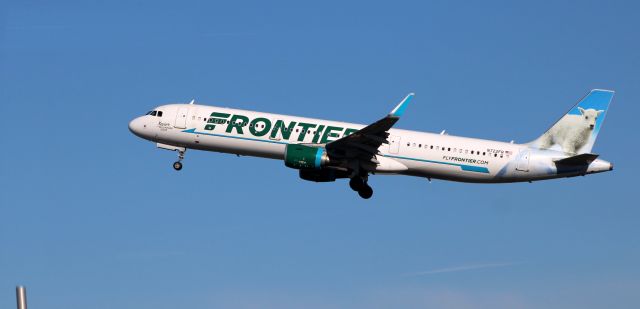 Airbus A321 (N722FR) - Shortly after departure is this 2018 Frontier Airlines Airbus 321-211 with "Xavier" the Mountain Goat getting the tail view in the Winter of 2022.