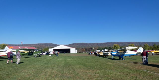 Piper PA-22 Tri-Pacer (N8838C) - With the Kittatinny Range of the Appalachian Mountains nearby is the Grimes Airfield with vintage aircraft for the annual Great Pumpkin Fly-In weekend from the Autumn of 2022.  The 1953 Blue/White Piper PA-22-135 Tri-Pacer is on the right.  