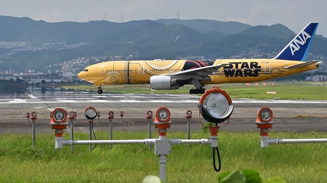 Boeing 777-200 (JA743A) - 24.Jul.2024br /On the Senri River riverbed at Osaka (Itami) International Airport.br /All Nippon Airways Boeing 777 (JA743A).br /Photographed with a wide-angle lens against the backdrop of a summer sky.br /Trimming.