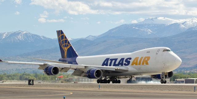 Boeing 747-400 (N496MC) - GTIs N496MC, operating as Giant Flt. 8200, completes a flight from Amsterdams Schiphol (EHAM) to Reno Tahoe International as it touches down on runway 34R yesterday afternoon.  The Atlas Air bird was arriving with a tremendously expensive cargo: it delivered the Gumball 3000 race cars from Amsterdam so the United States "leg" of the Stockholm-to-Las Vegas race could be resumed in San Francisco this morning.  As part of the photog group covering the arrival, my greatest thrill was this once-in-my-lifetime opportunity to be within 150 feet of a B747 that was landing literally a stones toss away.  This aircraft is truly The Queen Of The Skies; it was a gorgeous sight seeing it this closely.