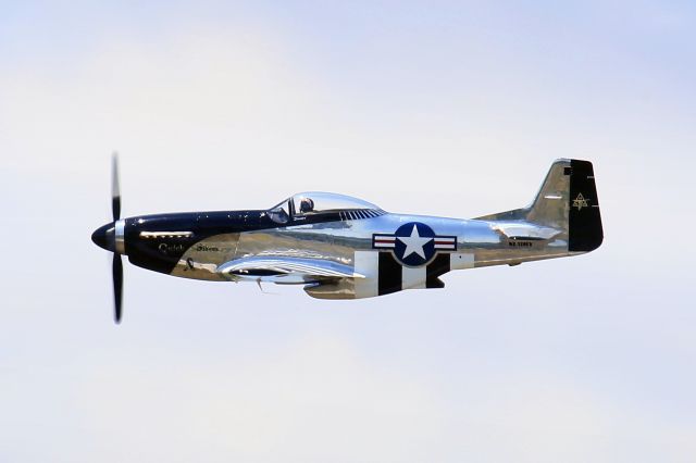 North American P-51 Mustang (N51HY) - North American P-51D Mustang, better known as "Quick Silver", does a fly-by over runway 24 at CFB Trenton, Ontario, Canada. This photo does not do justice as it fails to capture the magnificent roar of its Rolls-Royce V-1650-7 engine.