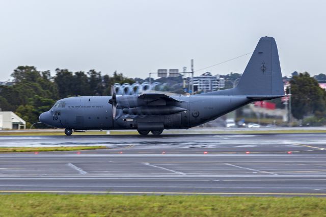 Lockheed C-130 Hercules (ANZ7002) - Royal New Zealand Air Force (NZ7002) Lockheed C-130H Hercules departing Sydney Airport on a damp morning. Yes, I know it is showing up as ANZ7002 on FA but the correct serial/tail number ia NZ7002.