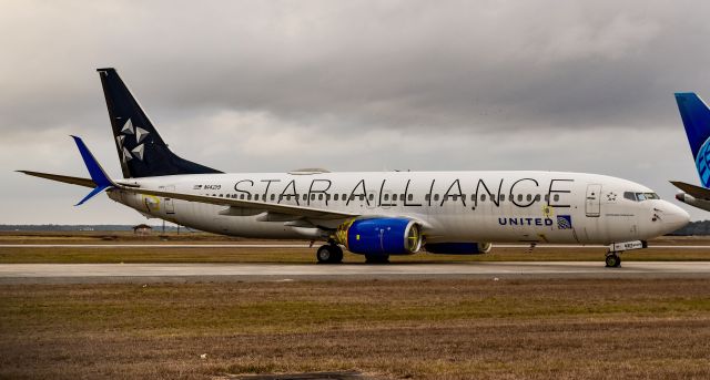 Boeing 737-800 (N14219) - The Star Alliance Special under the new United Airlines Livery w/ the painted blue engines sits at Bush Intercontinental Airport in Houston, Tx. 
