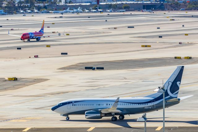 Boeing 737-700 (N101TD) - An Indianapolis Colts 737-700 taxiing while Southwest Tennessee One lands at PHX on 2/11/23 during the Super Bowl rush. Taken with a Canon R7 and Canon EF 100-400 II L lens.