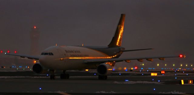 Airbus A300F4-600 (N135UP) - This handheld low-light click (ISO 400, f4.5, 1/4th second shutter) captures UPSs N135UP holding on Reno Tahoe Internationals taxiway Bravo, the fifth aircraft in a seven plane departure queue, awaiting its turn to take off.br /Although the first moment of dawn light is already lighting up the sky, a layer of icy fog at ground level is obscuring any illumination from the sky.  That same freezing fog is slowing the process of morning departures and has led to a line of seven aircraft (AA, SW, Delta, SW, UPS, American Eagle, and SW) waiting their turns to depart.