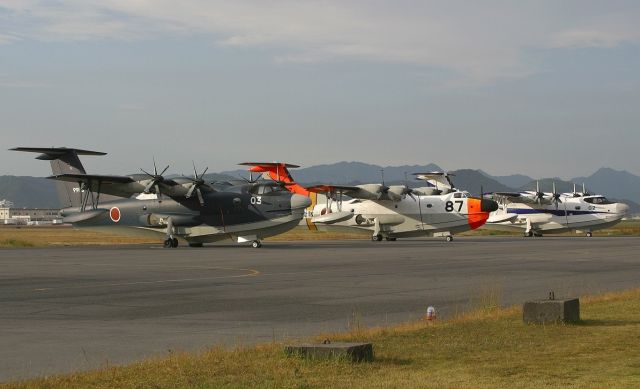 — — - Old ShinMaywa US-1A flanked by two new US-2 in different paint schemes as the sun was setting. Based at Iwakuni, Japan.