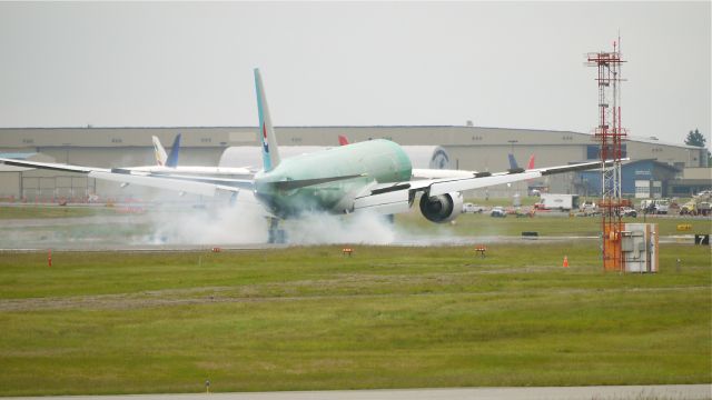 BOEING 777-300 (HL8250) - BOE955 makes tire smoke as it touches down on runway 16R and completes its maiden flight on 6/4/12. (LN:1023 c/n 37650).