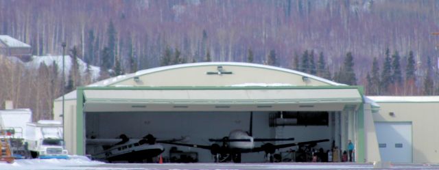 — — - Besides the EMB 110 having its port side engine serviced, you will notice next to it the Grumman Widgeon having its starboard engine being serviced too.