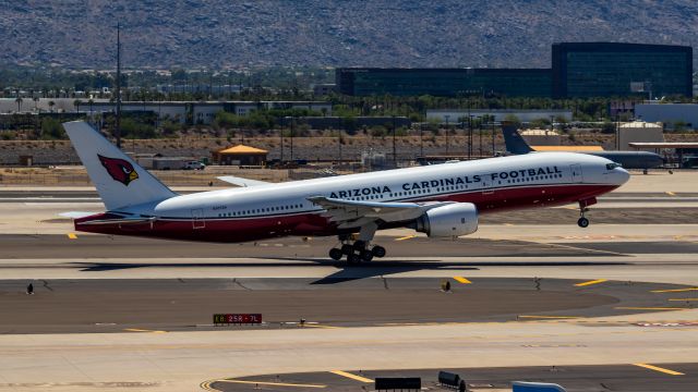 Boeing 777-200 (N867DA) - Arizona Cardinals 777-200 taking off from PHX on 8/28/22. Taken with a Canon 850D and Rokinon 135mm f/2 manual focus lens.