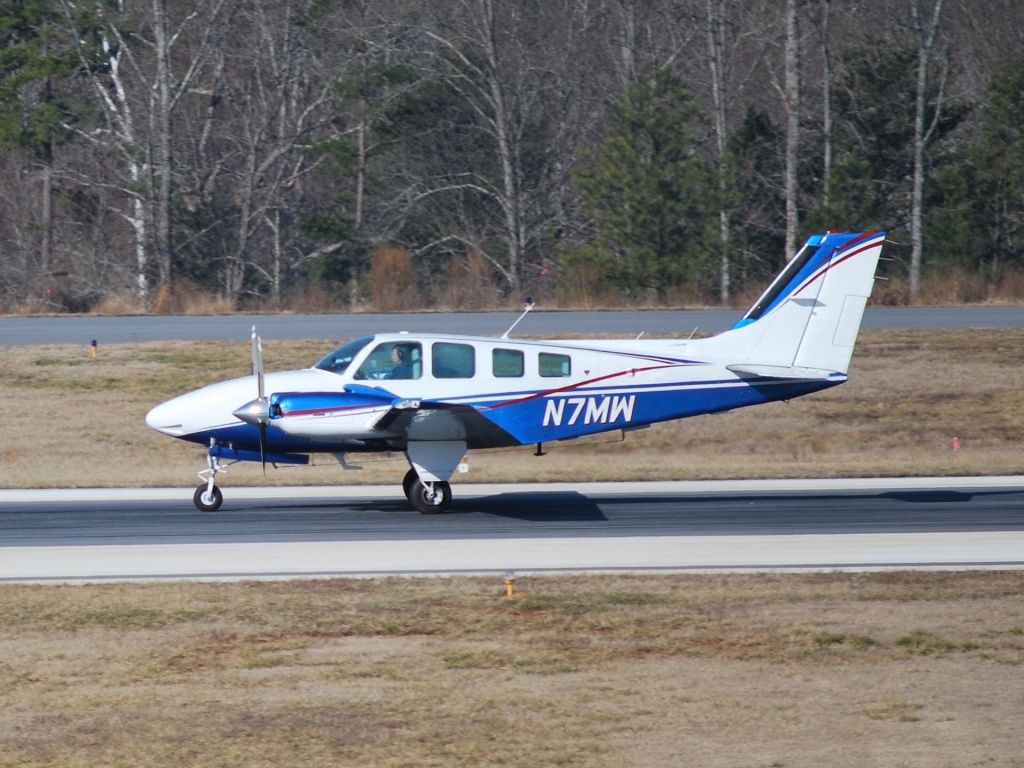 Beechcraft Baron (58) (N7MW) - Taking off from runway 20 at KJQF - 2/6/09