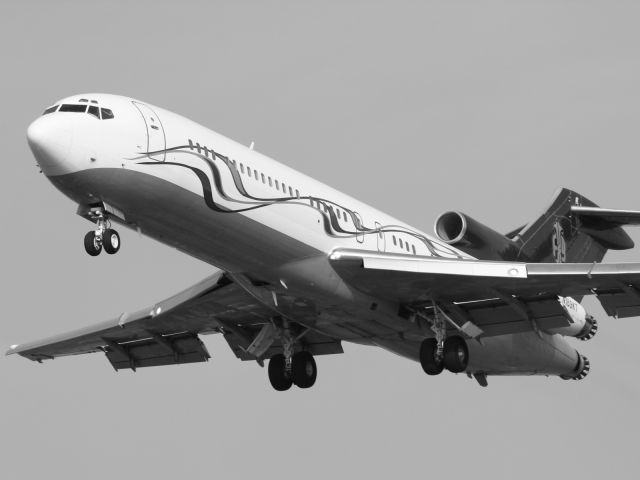 Boeing 727-100 (N169KT) - Trust me, with a murky sky and the aircraft sporting a faded maroon livery, this classic B727-200 looked better in Black and White.