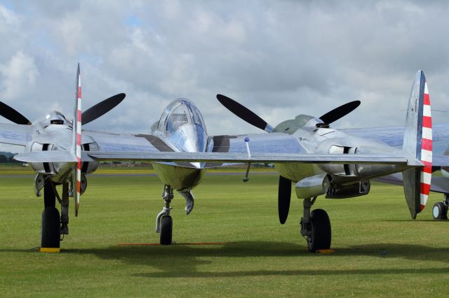 — — - The unmistakeable twin booms of the Lockheed P-38 Lightning.