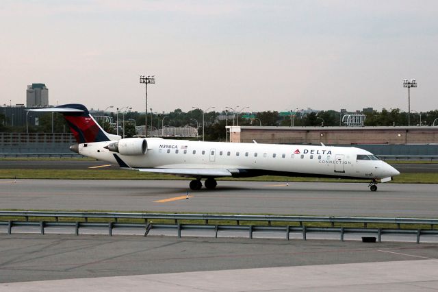 Canadair Regional Jet CRJ-700 (N398CA) - Taxi past the AA terminal for departure to Kansas.  Filling time waiting for my flight back to MAN.
