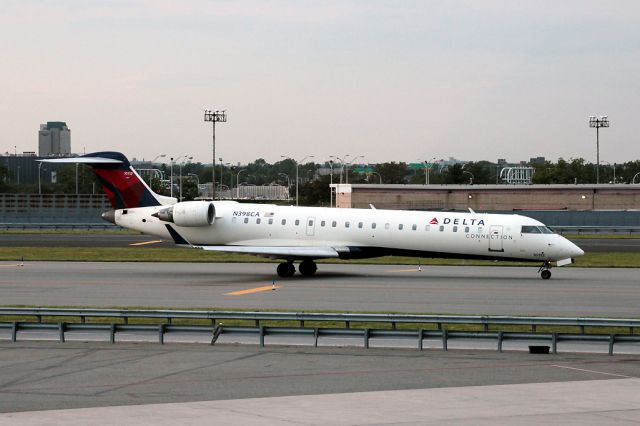 Canadair Regional Jet CRJ-700 (N398CA) - Taxi past the AA terminal for departure to Kansas.  Filling time waiting for my flight back to MAN.