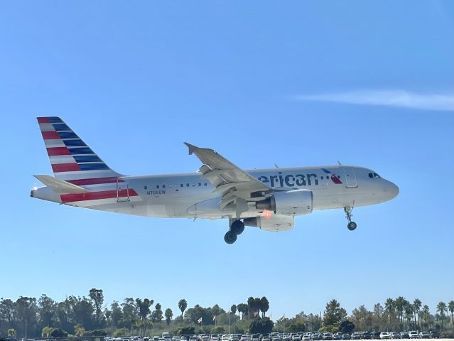 Airbus A319 (N709UW) - Crossing over the threshold of runway 25 at KSBA after a flight from KPHX