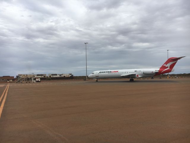 Fokker 100 (VH-NHC) - VH-NHC parked bay 1 @ YCHK while Fortescue Metals Group iron ore train pulls past for Port Hedland