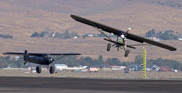 N2756 — - Although it looks as though pilot (and co-owner) Toby Ashley is flying N2756, his Carbon Cub named "Sarge," directly toward my position, in actuality he is flying sideways (left to right) as he is about to touch down on the dirt infield between the runway and the ramp.br /Not being a pilot myself, I don't know the proper word to describe what Toby is doing. I suppose I could say he is crabbing "Sarge" but my understanding of crabbing is that it is a maneuver a pilot uses when landing in a strong crosswind, but since there was no wind at all when Toby was executing this, I'll just call it an intense sideslip maneuver (and hope I'm using the correct word).br /No matter what his maneuver is called, it was severe. And it worked. Toby had Sarge down on the dirt ... and at a dead stop ... by the time he came abreast of me as I stood next to the ramp snapping pics. And just a few seconds after that, Sarge had been spun around 180 degrees and was again airborne headed back past that yellow flag marker.br /It was AWESOME!!