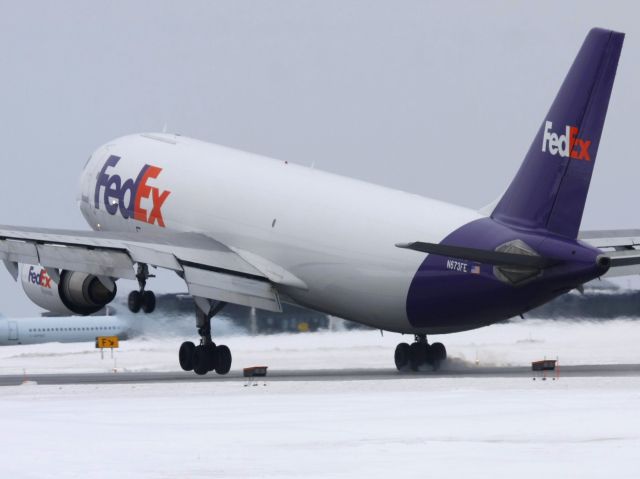 Airbus A300F4-600 (N673FE) - FDX152 Heavy touching the right main gear in a cross-wind landing.