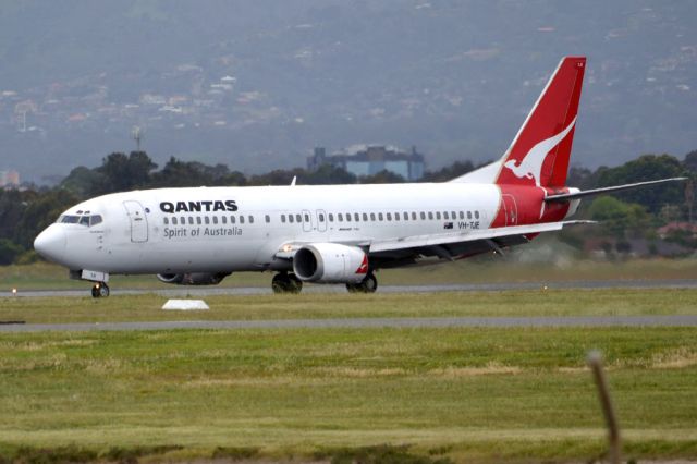 BOEING 737-400 (VH-TJE) - On taxi-way heading for Terminal 1 after landing on runway 23. Friday 5th October 2012.