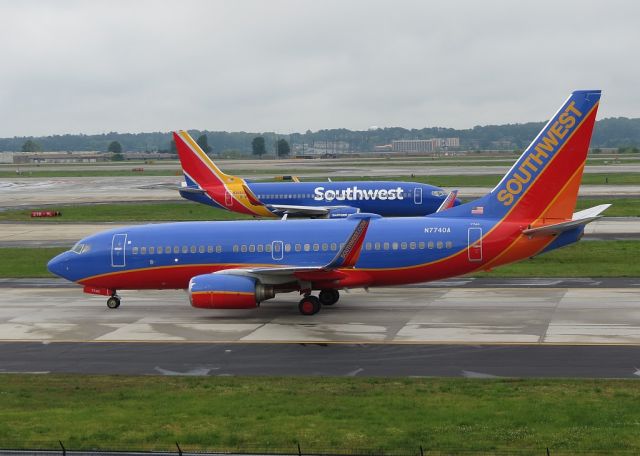 Boeing 737-700 (N7740A) - THE OLD AND THE NEW. SOUTHWEST 737-3H4 (N369SW) IN THE BACKGROUND.