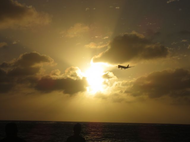 — — - Aruba sunset with aircraft on final for runway 11.