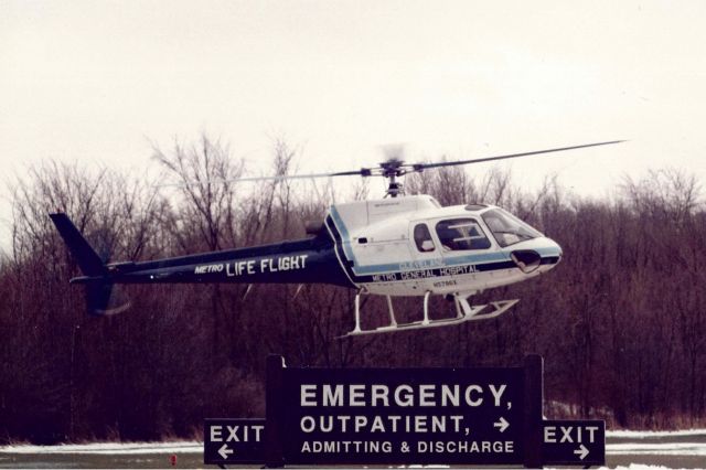 Eurocopter AS-350 AStar (N5786X) - Here’s one from my archives going back to March 1984. While home on leave from the Air Force, I accompanied my old friends at Geneva Fire Dept, where I began my firefighting career, to a Med-Evac standby at Geneva Memorial Hospital, now known as UH Geneva Medical Center. Using my old Pentax K-1000, I caught N5786X, an Aerospatiale AS-350B Ecureuil, operated by Omni Helicopters, Inc., landing on the pad. While Metro Life Flight began operations in September 1982, it was still considered risky to some and firefighters were often asked to standby with their apparatus during landing and takeoff.