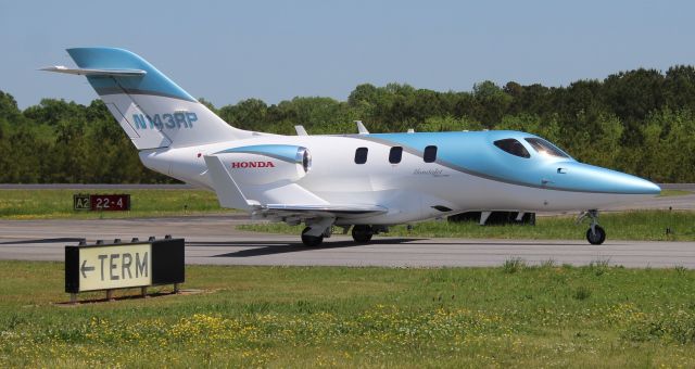 Honda HondaJet (N143RP) - Koury Aviation's 2019 model (serial number 42000143) HondaJet Elite taxiing for takeoff at Boswell Field, Talladega Municipal Airport, AL during the GEICO 500 Race Weekend - April 22, 2023.