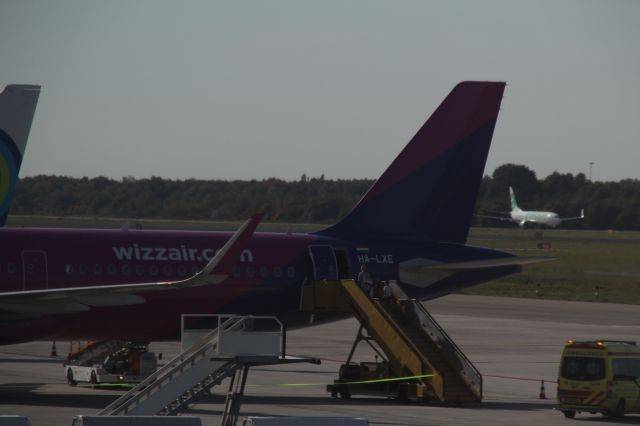 HA-LXE — - Boeing 737 of Transavia behind the tail of Airbus A321 of WizzAir at Eindhoven Airport (Holland). (Saturday, October 13th, 2018)