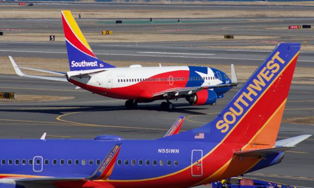 Boeing 737-700 (N931WN) - (2/21/2020) Lone Star One taxies over to runway 27 after pushing back. Framed by N551WN also a B737.