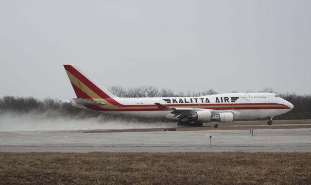 Boeing 747-400 (N741CK) - Powering off 18L on a raining Sunday afternoon