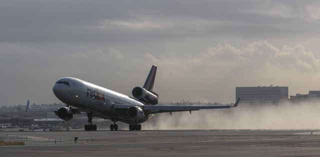 Boeing MD-11 (N631FE) - Work was done to runway 25L at LAX last night. FedEx did the final cleanup with this mornings take off. 14 May 2015 07:04 am PDT.