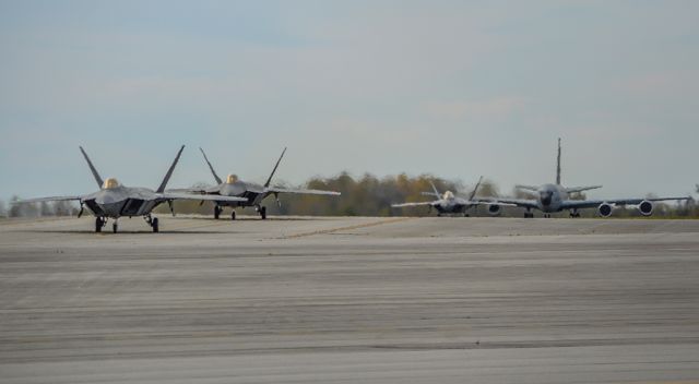 Lockheed F-22 Raptor — - Three F-22s from the 1st Fighter Wing taxiing out at LCK after a 6 day stay to avoid Hurricane Matthew while a local KC-135 from the 121st Aerial Refueling Wing taxis out for a training flight.