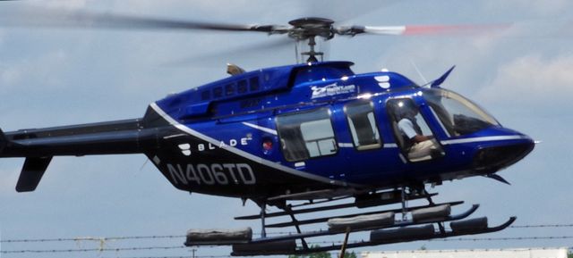 Bell 407 (N406TD) - LINDEN AIRPORT-LINDEN, NEW JERSEY, USA-JULY 15, 2021: A helicopter operated for the Blade Company is seen taking off shortly after refueling at Linden Airport.